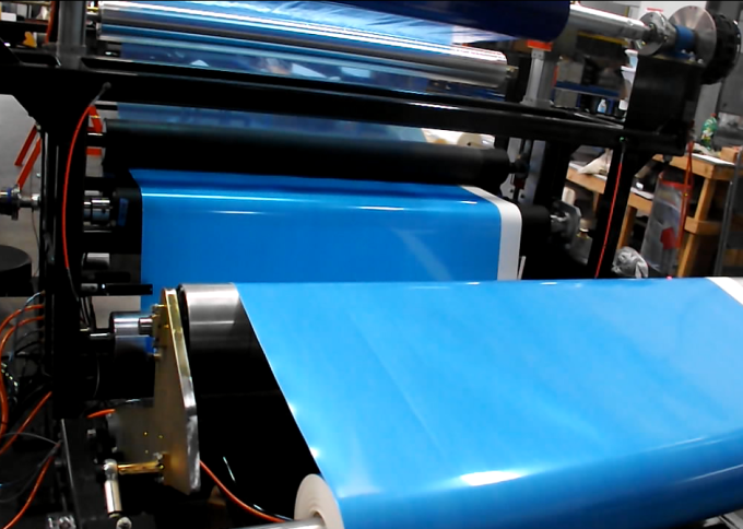Industrial Laminator Walco 813 - detail of blue protective film application on rollers.