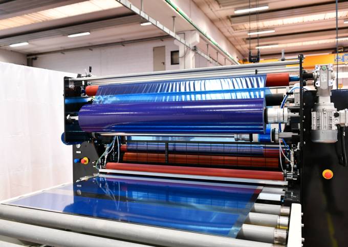 Industrial Laminator TX by Walco - application of blue protective film on large surfaces.