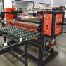Industrial Laminator Walco 822 - wide shot of the complete in-line laminating system with entry and exit conveyor support