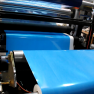 Industrial Laminator Walco 813 - detail of blue protective film application on rollers.