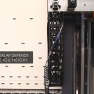 Industrial vertical laminator VX2 by Walco - close-up of the vertical film overlap cutting system.